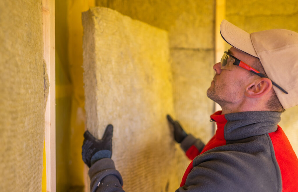 Man examining a large stone slab indoors.